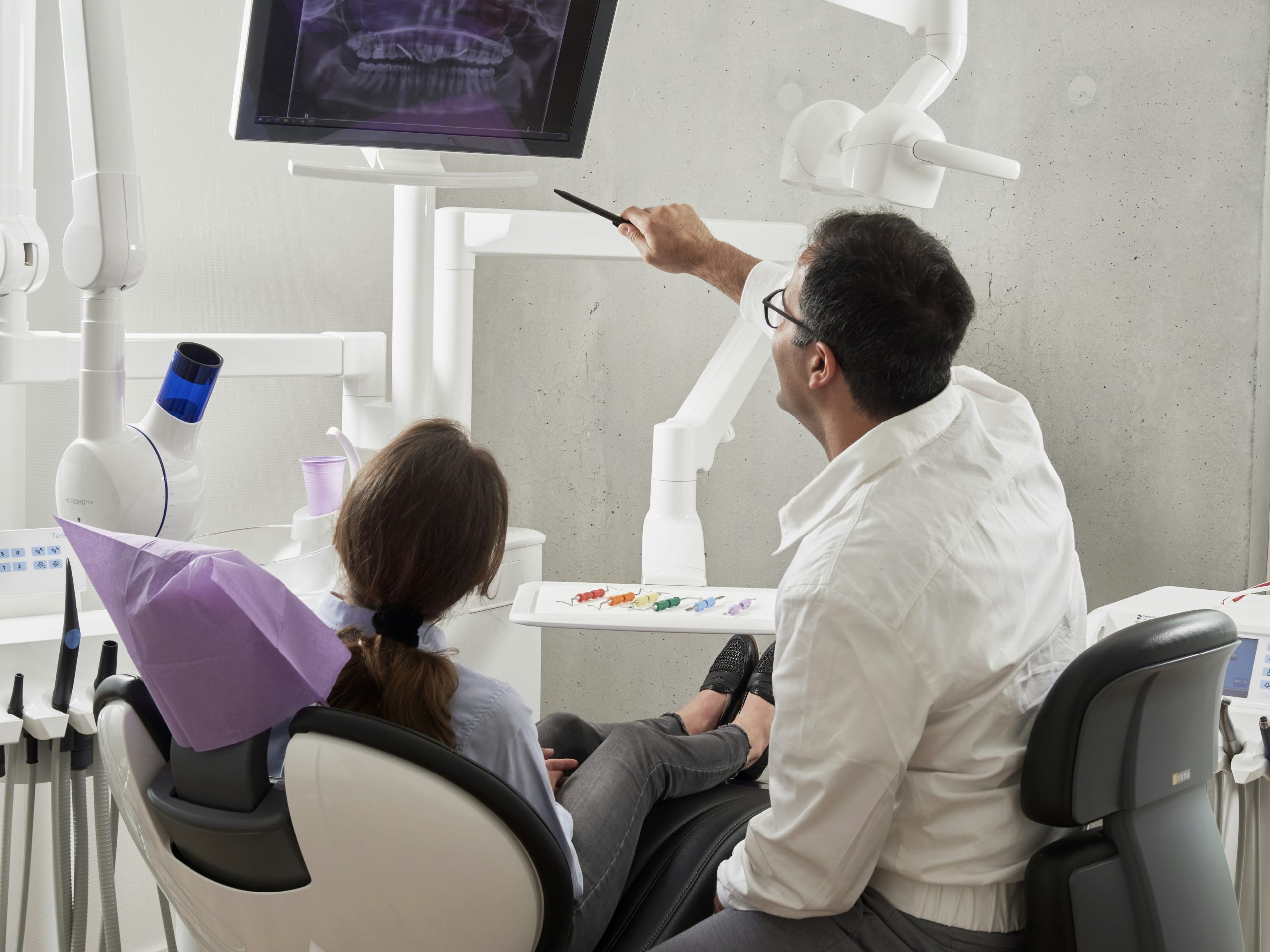 Orthodontist fitting lingual braces on the inner surface of a patient's teeth at a Sydney specialist orthodontic clinic